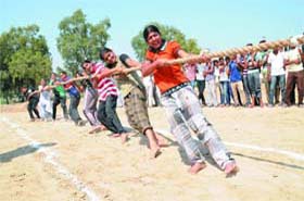 Trial of strength: Students from Talwandi Sabo and Mandi Kalan take part in the tug-of-war contest during the district-level sports tournament at the multipurpose sports stadium in Bathinda on Wednesday