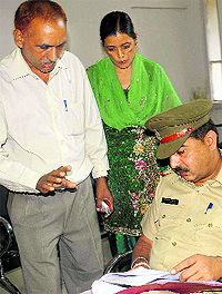Om Prakash and his wife submit a complaint to a police official in Chandigarh on Wednesday