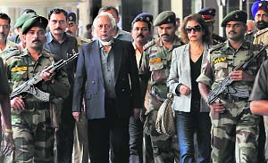 Lt Gen KS Brar (retd) (C) being escorted out of the Chhatrapati Shivaji International Airport after his arrival from London in Mumbai on Wednesday.