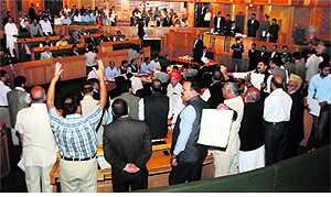Legislators of the PDP and BJP protest in the Assembly on Wednesday