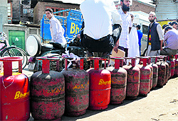 People wait for their turn outside a gas agency