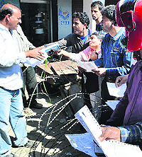 Consumers show their documents for verification in Srinagar on Wednesday