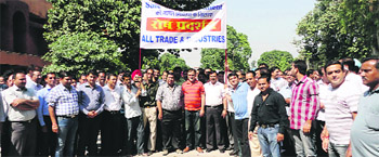 Traders and industrialists take out a protest march in Mandi Gobindgarh on Wednesday. 