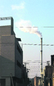 Smoke billowing out of a chimney of an industrial unit poses a serious threat to the health of residents