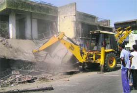 An illegal building being demolished near Railway Chowk in Sangrur on Wednesday
