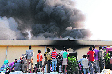 Dense smoke billows out of a godown of Delhi Punjab Goods Carrier Private Limited on the Majitha-Verka bypass road