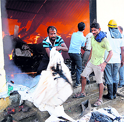 a fireman tries to douse flames in Amritsar on Thursday