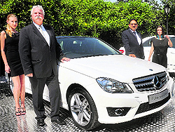 Mercedes-Benz India MD & CEO Peter Honegg (L) and sales & marketing director Debashis Mitra pose with the 2012 Sport limited editions of the companys flagship sedans  the C-Class and E-Class, priced at Rs 29.9 lakh and Rs 39.9 lakh, respectively, at their launch in New Delhi on Thursday. The models feature an added AMG Sports package  similar to the one seen on the new C-Class in the form of the C-Class AMG Performance Edition that was introduced in India back in June this year. Mercedes-Benz said nearly 40% of its India portfolio would consist of premium cars priced Rs.20-25 lakh to meet the growing demand in the luxury segment and regain market share lost to rivals
