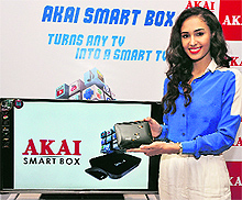Femina Miss India Earth 2011 Hasleen Kaur poses with the Akai Smart Box at a press conference in New Delhi on Thursday. The device, based on the Android platform, transforms any television set into a smart TV and is priced at Rs 6,590