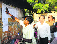 An official pastes a vacation notice at Pandit Colony in Sector 52, Chandigarh, on Thursday. 