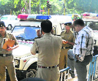 Police officials investigate the spot where a girl had complained of eve-teasing by a traffic policeman.