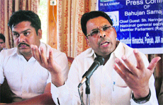 National BSP general secretary Narender Kashyap (right) addresses mediapersons in Shimla on Thursday.