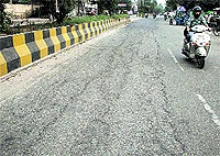 A stretch of dilapidated Ladowali road near District Administrative Complex where no patch-work has been done