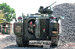 A Turkish soldier steps out of an armoured vehicle on the border with Syria on Thursday