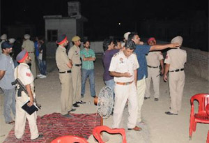 Police investigating the scene of the crime in Balla Ram Nagar on Friday evening. 