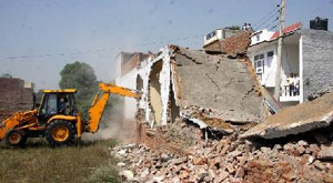 The unauthorised shops being demolished in North Estate on Friday. 