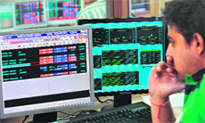 A stock dealer watches share prices on his terminal at a brokerage house in Mumbai. Trading on the NSE, the country's second-biggest stock exchange, was halted on Friday morning after abnormal orders worth Rs 650 crore from a local brokerage firm crashed the main index