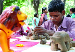 The visually impaired children participate in a clay model-making competition at  Delhi Zoo on Friday. Tribune photo: Manas Ranjan Bhui