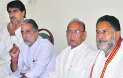 Krishan Pal Gurjar (2nd from left), president of the Haryana BJP, and HJC leader Dharam Pal Malik (2nd from right) address a press conference in Karnal on Friday. Tribune photo: Ravi Kumar
