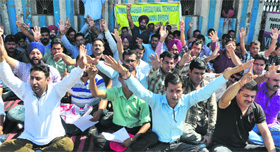 Members of the Jammu and Kashmir Agricultural Technocrats Association hold a protest in Jammu on Friday.