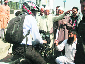 Residents block a road in protest against LPG shortage in Srinagar on Friday.