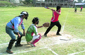 A player readies for a strike during the 7th J&K State-Level Baseball Men Championship in Srinagar on Friday.