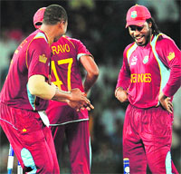 Chris Gayle hits a six during the semifinal against Australia (L) and later dances to celebrate the win in Colombo on Friday. AFP/ Reuters 