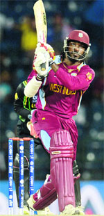 Chris Gayle hits a six during the semifinal against Australiaon Friday. AFP/ Reuters