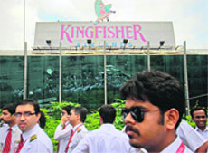 Striking employees stand in front of the Kingfisher Airlines office in Mumbai during a protest against the company on Friday following the suicide of a staffers wife. The carrier has grounded its fleet for another week after failing to resolve the impasse with staff over salaries that have gone unpaid for seven months, deepening the crisis at what was once India's no. 2 carrier.  Reuters