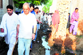 Inspects drains during a night camp programme at Choushala village in Kaithal district on Saturday.