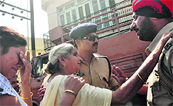 Police officers try to pacify kin of victims at the blast site in Ludhiana on Saturday