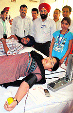 Volunteers donate blood during a blod donation camp on the GNDEC campus in Ludhiana