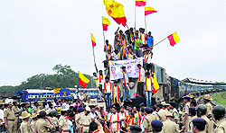 Protesters stop a train over the Cauvery water issue at Hubli in Karnataka on Saturday