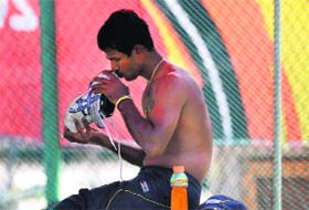 Sri Lankas Nuwan Kulasekara kisses his shoe during a training session