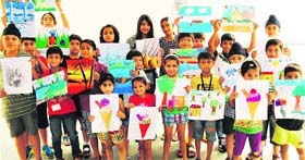Children show their paintings during a competition at a community centre in Sector 48, Chandigarh, on Sunday