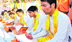 Brahmin scholars recite verses of 18 chapters of  the Bhagwad Gita at the Ganga ghat.