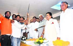 Congress candidate from the Tehri bypoll Saket Bahuguna being presented a sword by youth group members in the presence of Union minister Rajeev Shukla in Dehradun on Sunday