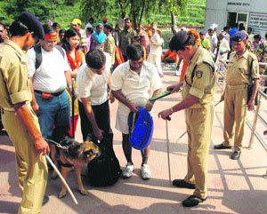 CRPF jawans frisk people as part of the tightened security for the upcoming Navaratras in Katra town. 