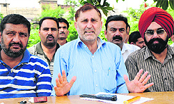 Members of the J&K Government Employees address mediapersons in Jammu on Sunday