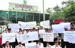Kingfisher employees show placards at a protest walk from the airport to Kingfisher house in Mumbai.  PTI