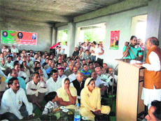 Chief Minister PK Dhumal addresses BJP workers at Tarkwari in Badsar, Hamirpur district, on Monday.