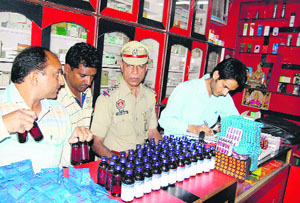 Police and health officials seize banned drugs from a chemist shop in Jalandhar on Monday. 