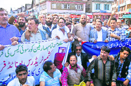 Members of various unions hold a demonstration in Sringar on Monday.