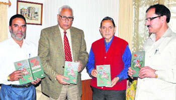 Office-bearers of Meezan Publishers present a copy of the Urdu version of the Jammu and Kashmir Constitution to Governor NN Vohra in Srinagar on Monday.