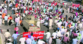 Railway employees block traffic at the main intersection of the Jagraon bridge.