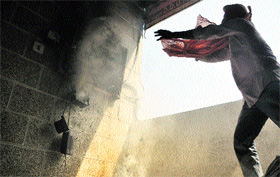 A man tries to douse a fire in a building at the Bharat Nagar Chowk in Ludhiana on Monday.