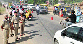 Senior traffic police officials inspect the traffic plan at the Sidhwan canal bridge on Ferozepur Road in Ludhiana on Monday.