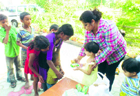 Students distribute eatables among slum children in Dugri on Monday.