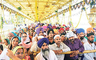 Devotees pay their to obeisance to the fourth Sikh Guru Ramdass on his birth anniversary in Amritsar on Tuesday.