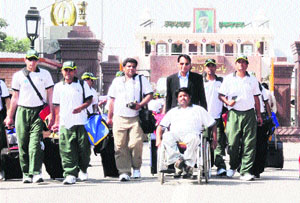 A 30-member delegation of handicapped cricketers from Pakistan crosses over to India the Wagah border on Tuesday.